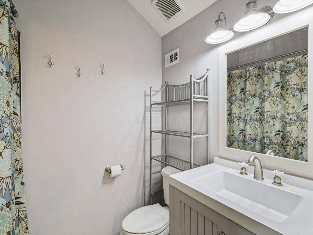 Vanity with an integrated sink, brushed nickel faucet, and beadboard paneling