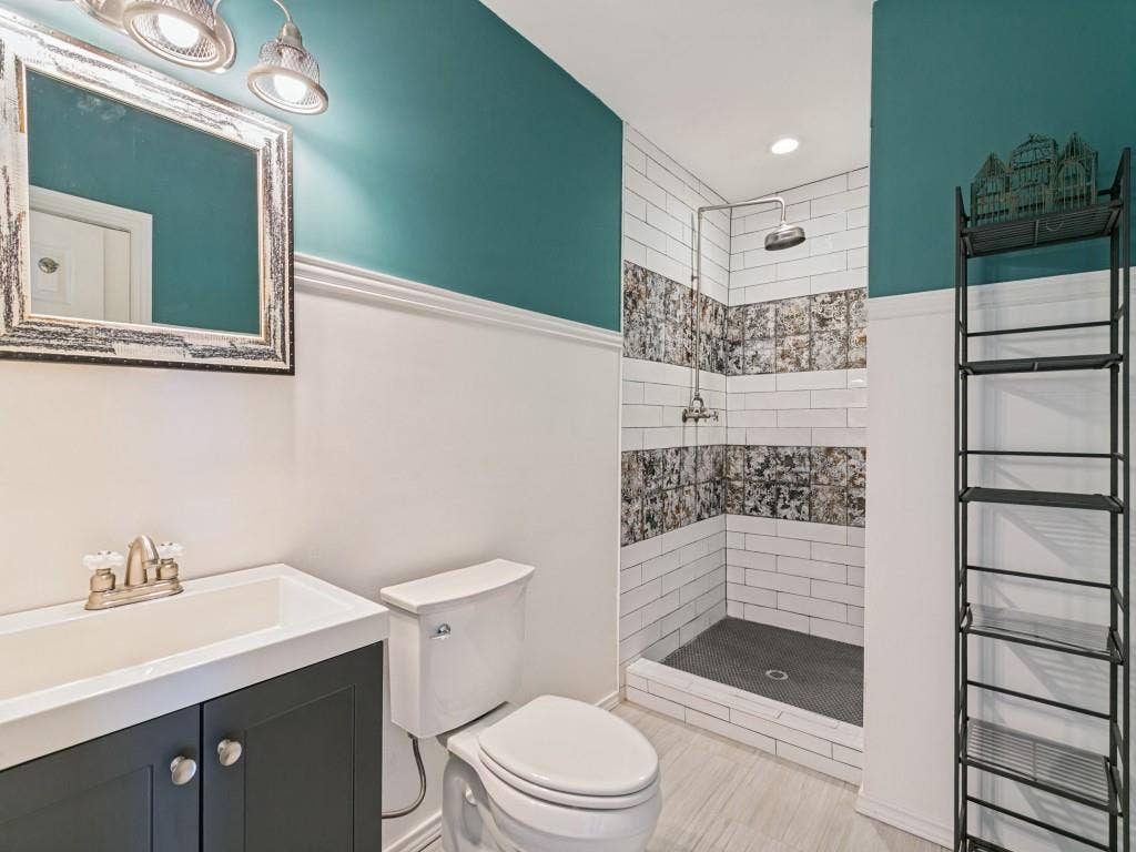 Tiled shower with mosaic, light, and a rainfall showerhead