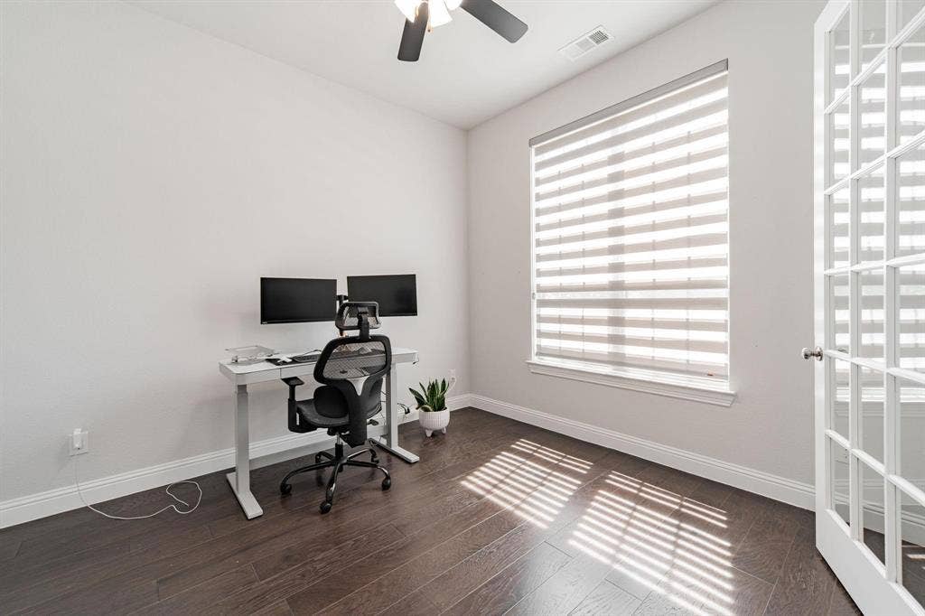 Hardwood-finish flooring, recessed lighting, ceiling fan, and French-style door