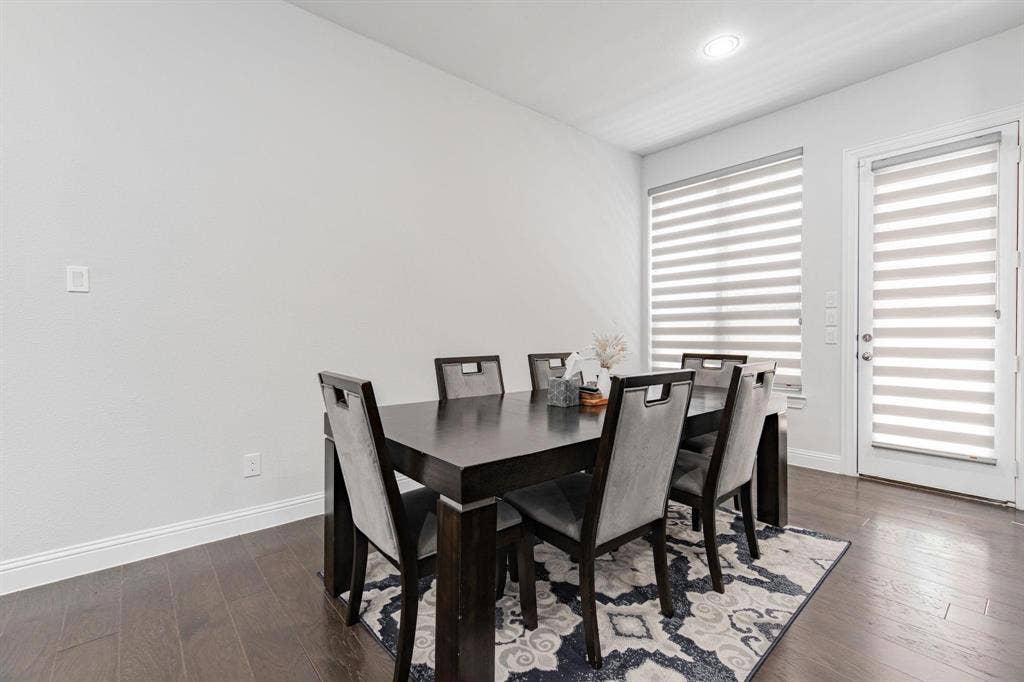 Wood-finish flooring, recessed lighting, and a white interior door