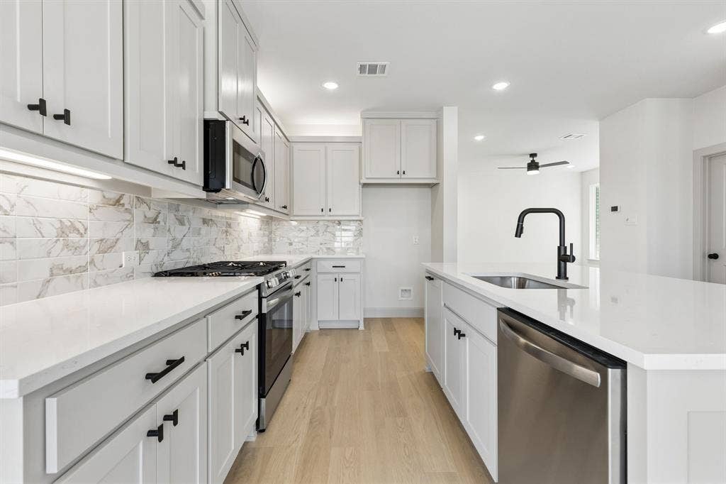 3716 Malamute Run, McKinney, TX 75071 Beautiful cabinetry, gorgeous counter tops and designer backsplash effortlessly pair with contemporary stainless steel to create a kitchen for the ages!