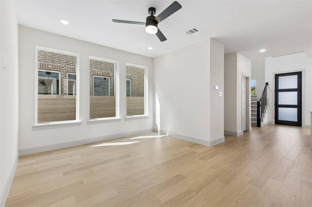 3716 Malamute Run, McKinney, TX 75071 A wall of windows floods this family room with natural light creating a bright and inviting space.