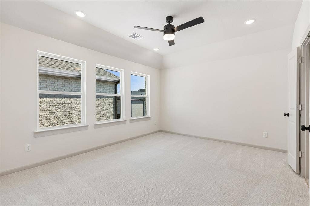 3716 Malamute Run, McKinney, TX 75071 With high ceilings, plush carpeting and a wall of windows, this owner's suit is the perfect place for rest and relaxation.