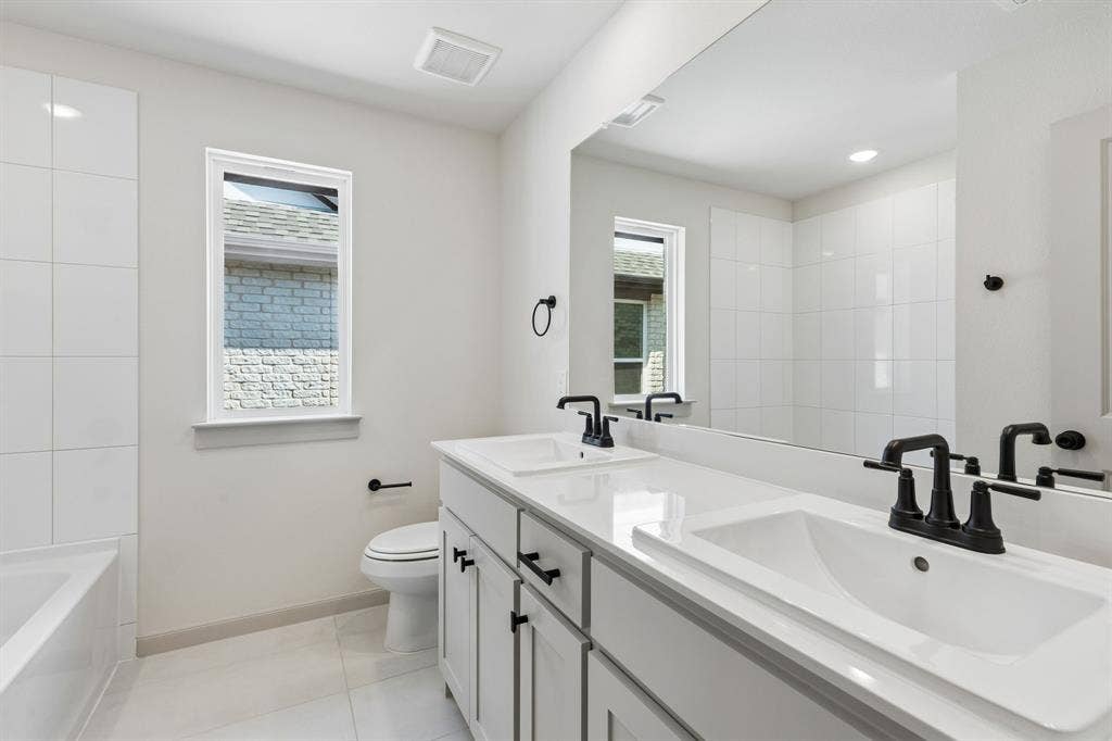 3716 Malamute Run, McKinney, TX 75071 With vanity space for two, friends and family will feel right at home in this thoughtfully designed guest bath.