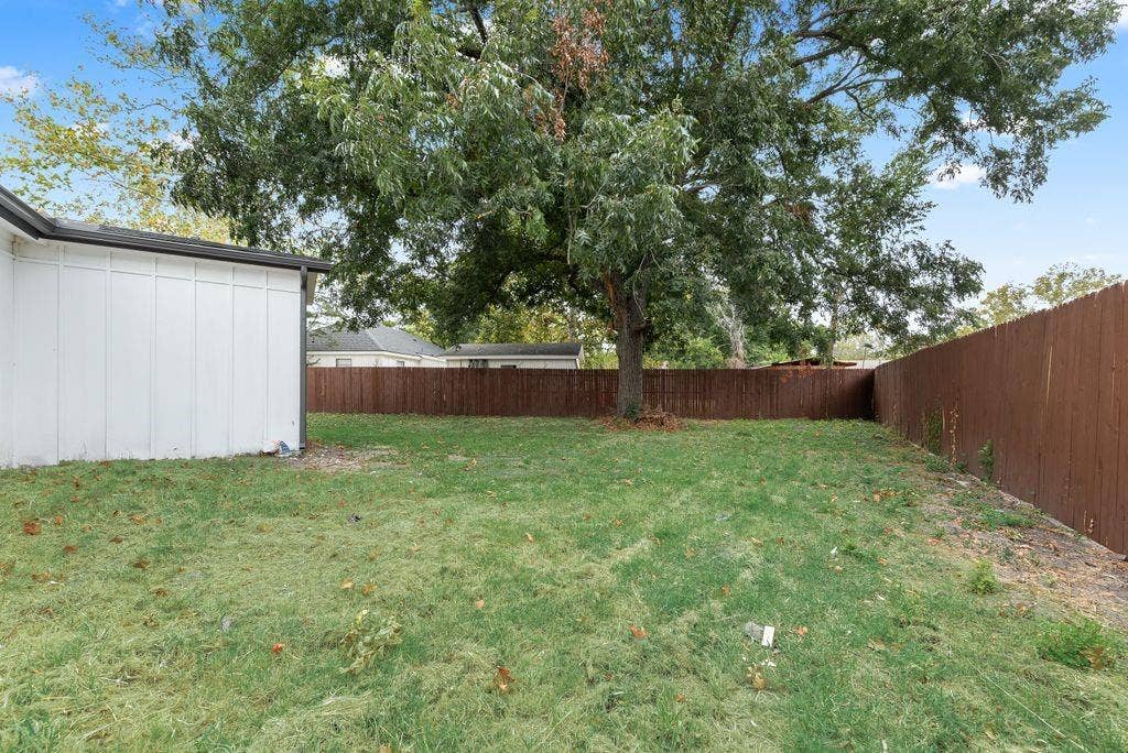 307 N 4th Street, Crandall, TX 75114 Expansive grassy yard with mature trees and a perimeter privacy fence