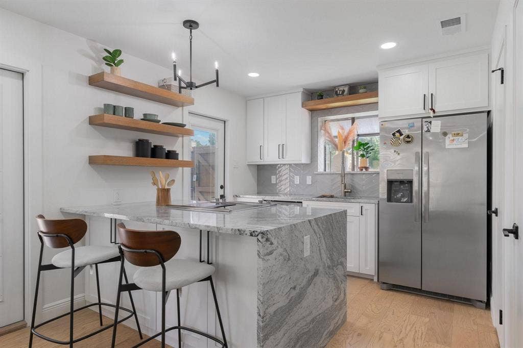 1805 W Spring Creek Parkway, #MM2, Plano, TX 75023 Kitchen featuring a waterfall island, white cabinetry, stainless steel refrigerator, light wood-finish flooring, and open shelving