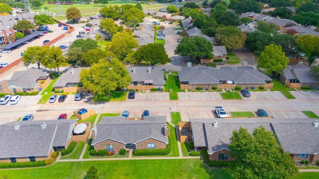 1805 W Spring Creek Parkway, #MM2, Plano, TX 75023 Aerial perspective showcasing a residential community with abundant mature trees and manicured green spaces