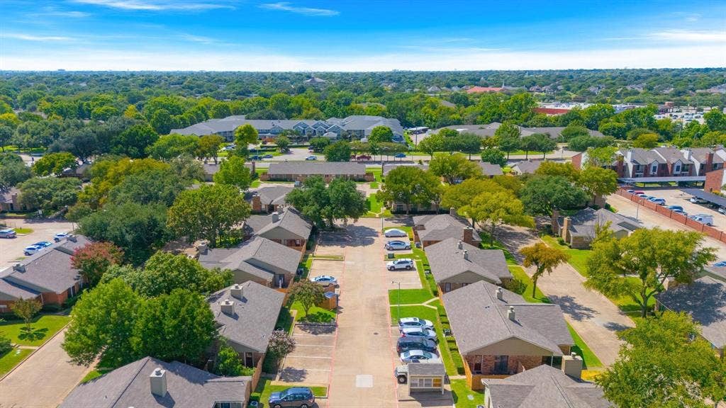 1805 W Spring Creek Parkway, #MM2, Plano, TX 75023 Expansive property featuring multiple single-story and multi-story buildings, mature trees, dedicated surface parking, and paved roadways