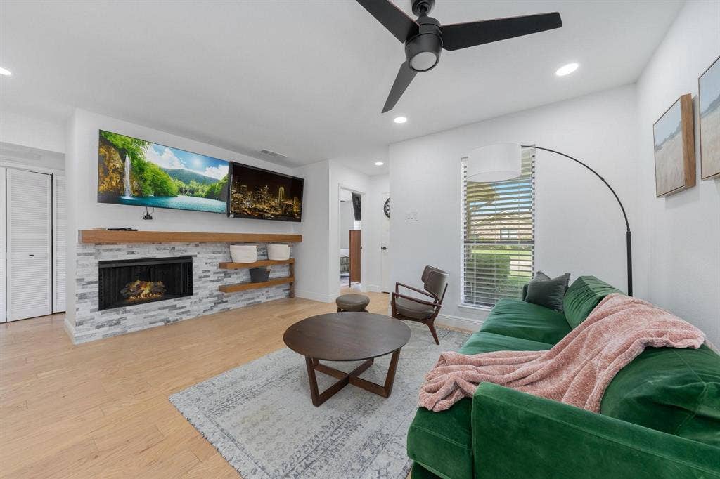 1805 W Spring Creek Parkway, #MM2, Plano, TX 75023 Wood-finish flooring, recessed lighting, and a black ceiling fan complement the white walls