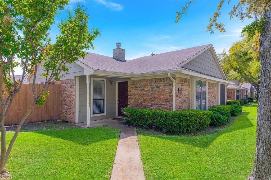 1805 W Spring Creek Parkway, #MM2, Plano, TX 75023 Brick facade with light gray siding, dark asphalt shingle roof, and a prominent front door