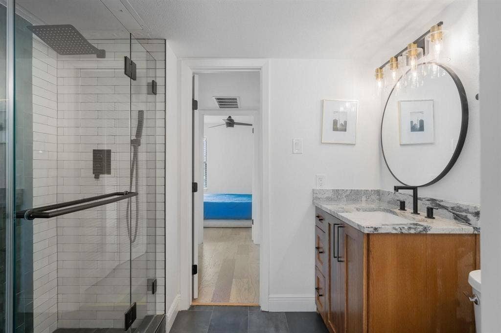 1805 W Spring Creek Parkway, #MM2, Plano, TX 75023 Glass-enclosed shower with subway tile surround and dark-finish fixtures