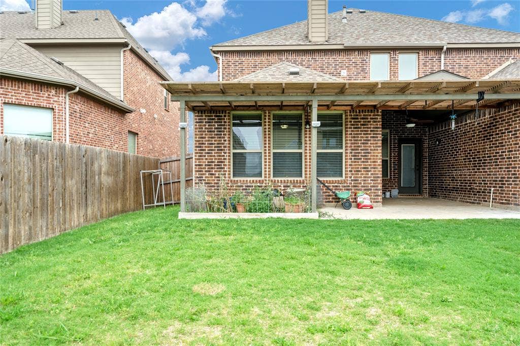 Expansive grass lawn with a wood privacy fence
