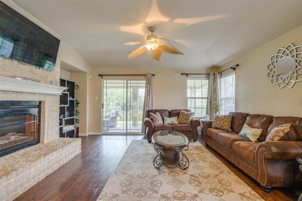 2035 Matagorda Lane, Grand Prairie, TX 75052 Fireplace featuring a light-colored brick surround