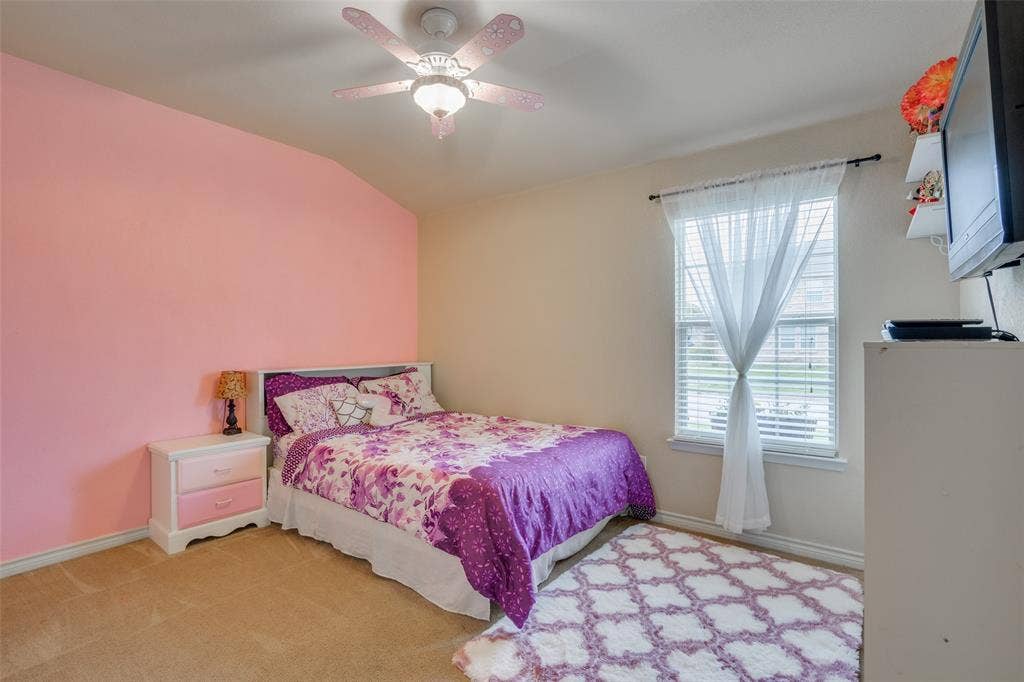 2035 Matagorda Lane, Grand Prairie, TX 75052 Carpeted room with vaulted ceiling and ceiling fan with integrated lighting