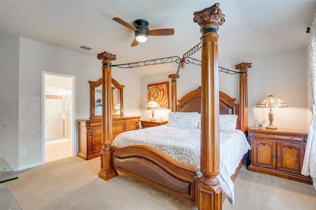 2035 Matagorda Lane, Grand Prairie, TX 75052 Carpeted bedroom featuring a ceiling fan, coved ceiling, and an open doorway to a bathroom with a glass-enclosed shower