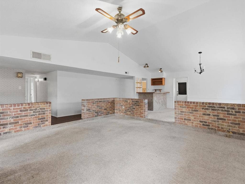 7612 Jerome Drive, Plano, TX 75025 Vaulted ceilings, a built-in wet bar with wood cabinetry, and brick half-walls