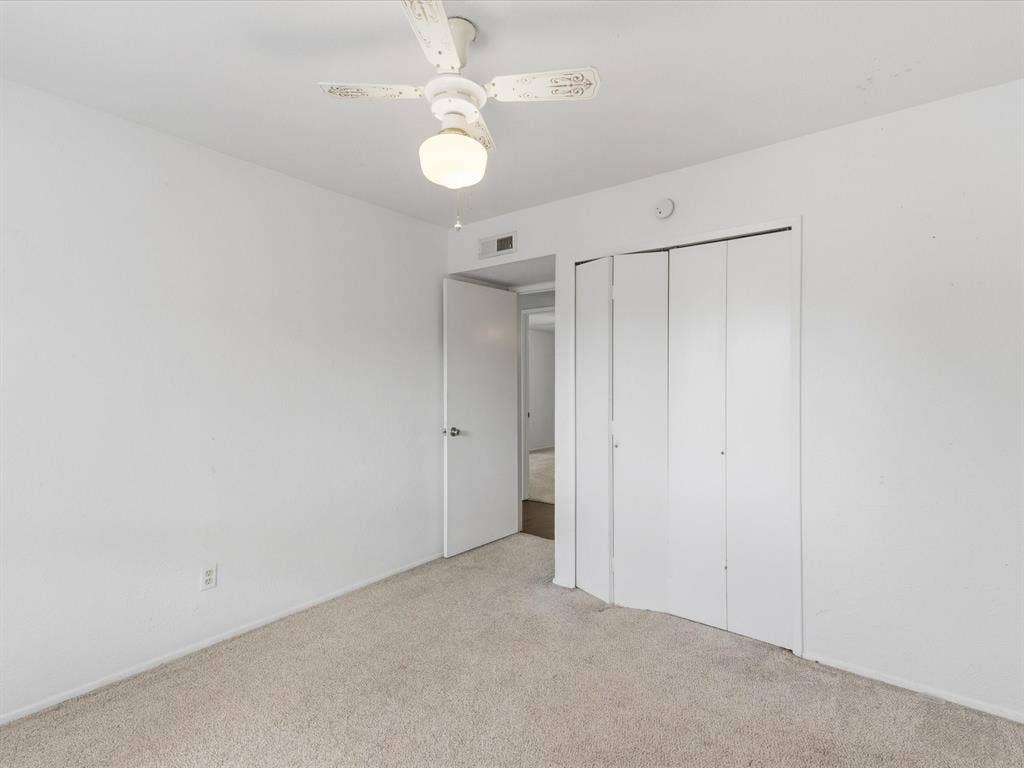 7612 Jerome Drive, Plano, TX 75025 Plush neutral-toned carpeting, white walls, white bifold closet doors, and an overhead ceiling fan with lighting