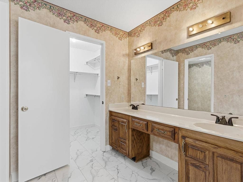 7612 Jerome Drive, Plano, TX 75025 Dual vanity with wood-finish cabinetry and integrated sinks