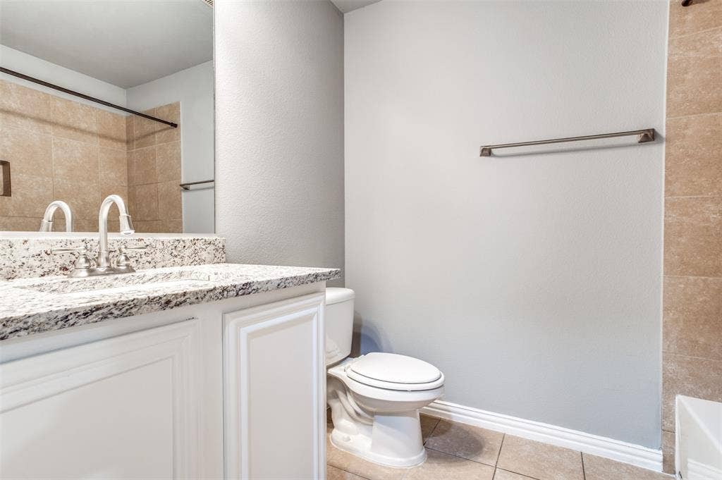 2364 Calendar Court, Grand Prairie, TX 75050 Vanity with a solid surface countertop, integrated sink, and white cabinetry