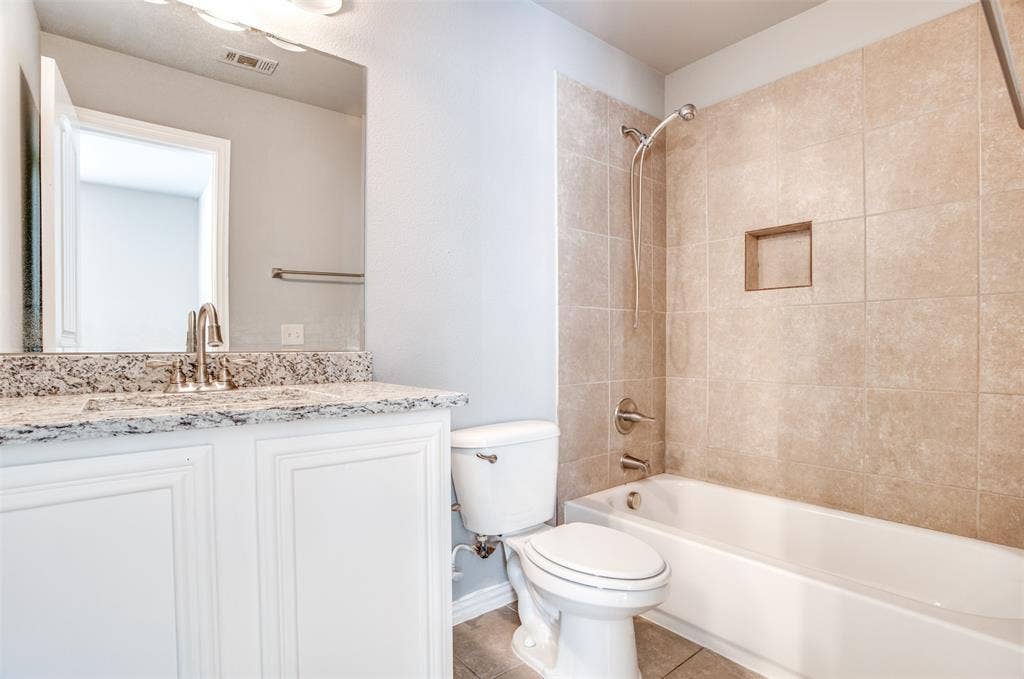 2364 Calendar Court, Grand Prairie, TX 75050 White vanity with a stone-finish countertop and undermount sink