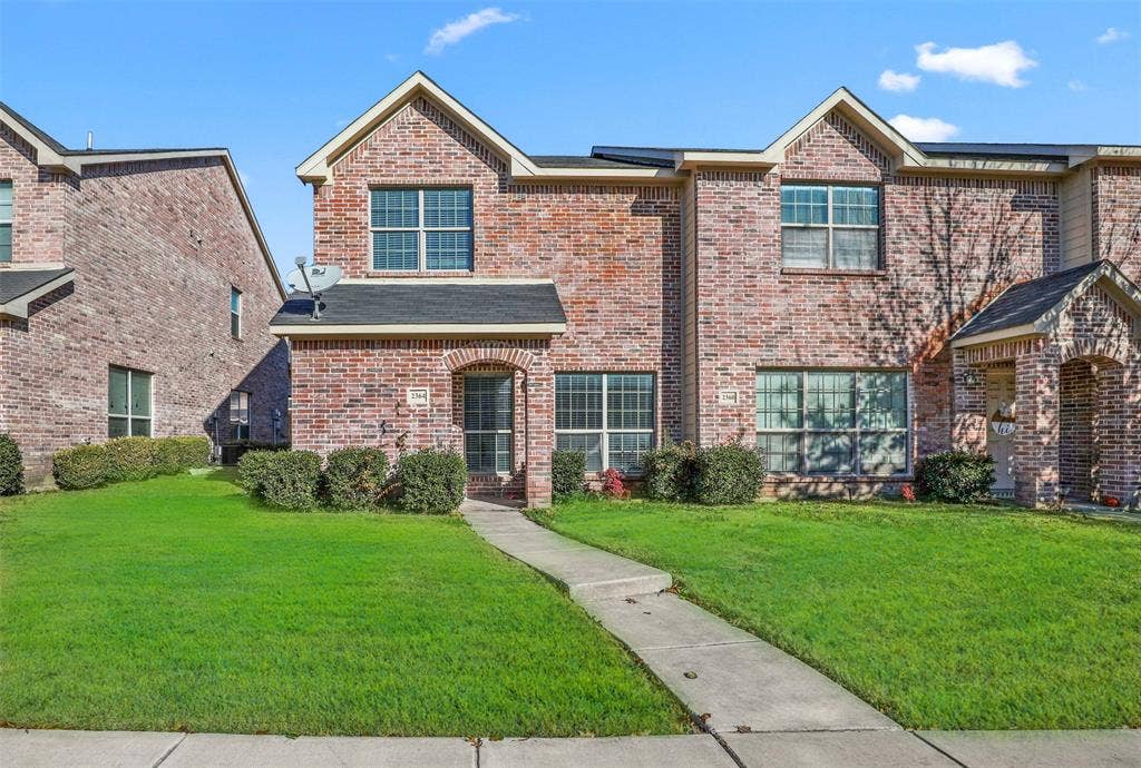 2364 Calendar Court, Grand Prairie, TX 75050 Brick facade with multiple gables, arched entry, and a concrete walkway