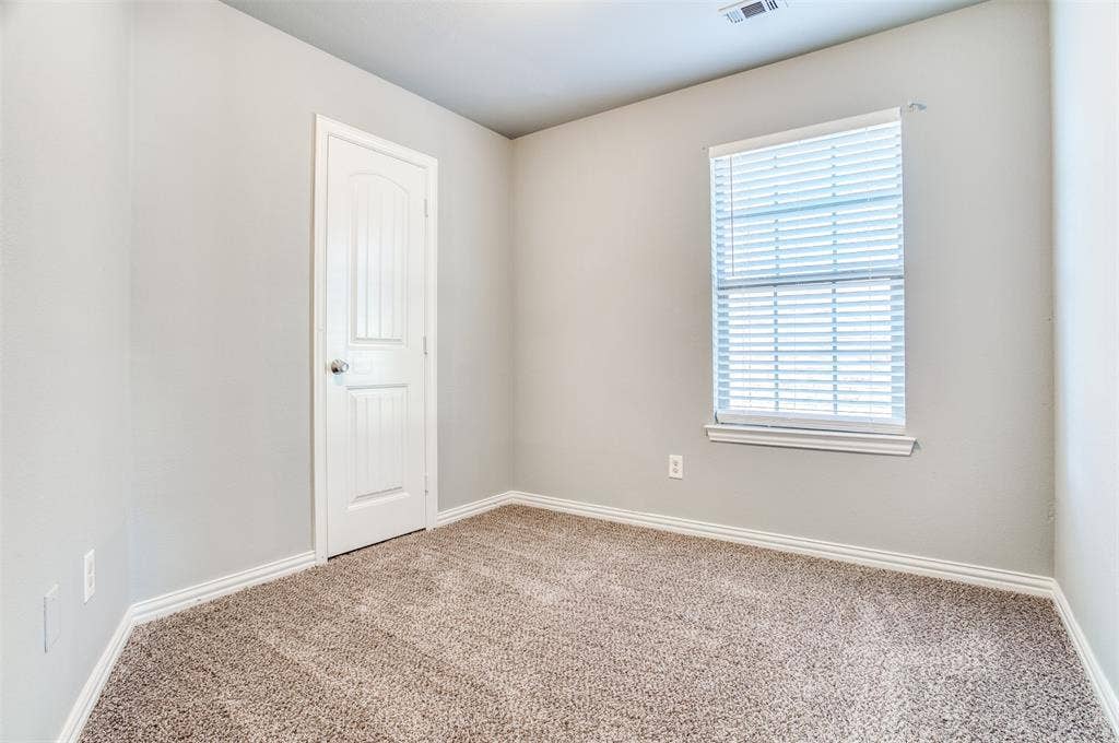 2364 Calendar Court, Grand Prairie, TX 75050 Neutral wall paint, textured carpeting, white trim, and a window with blinds
