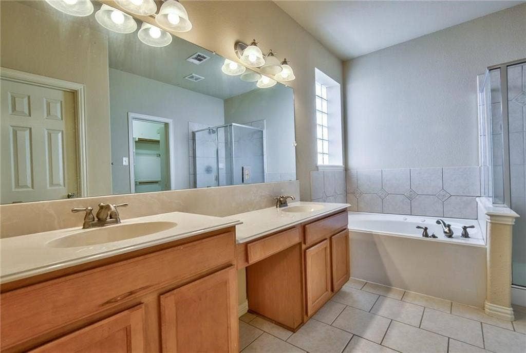 7108 Jessup Court, Plano, TX 75074 Dual vanity with undermount sinks, wood cabinetry, and a full-width mirror