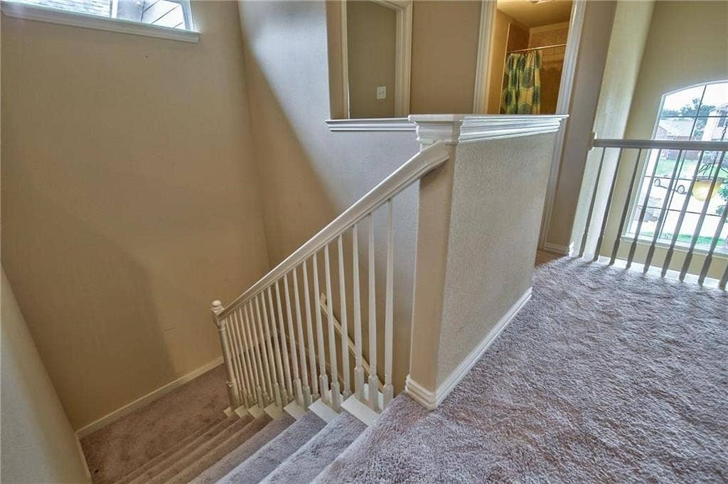 7108 Jessup Court, Plano, TX 75074 Carpeted stairs with white balusters and handrail