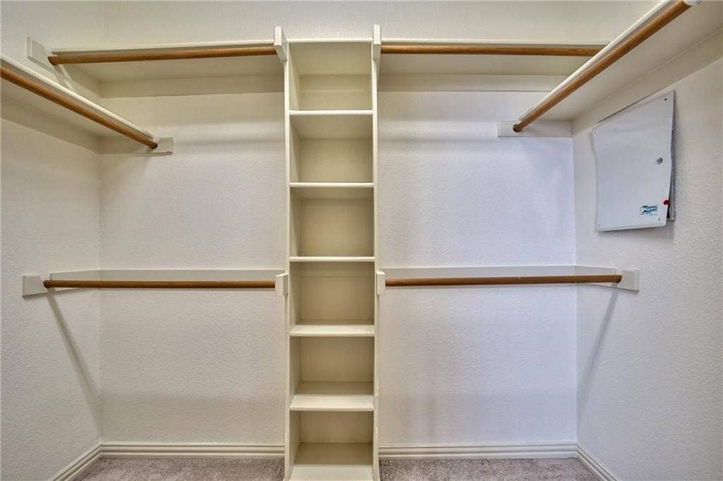 7108 Jessup Court, Plano, TX 75074 Custom closet organization system featuring shelving and hanging rods
