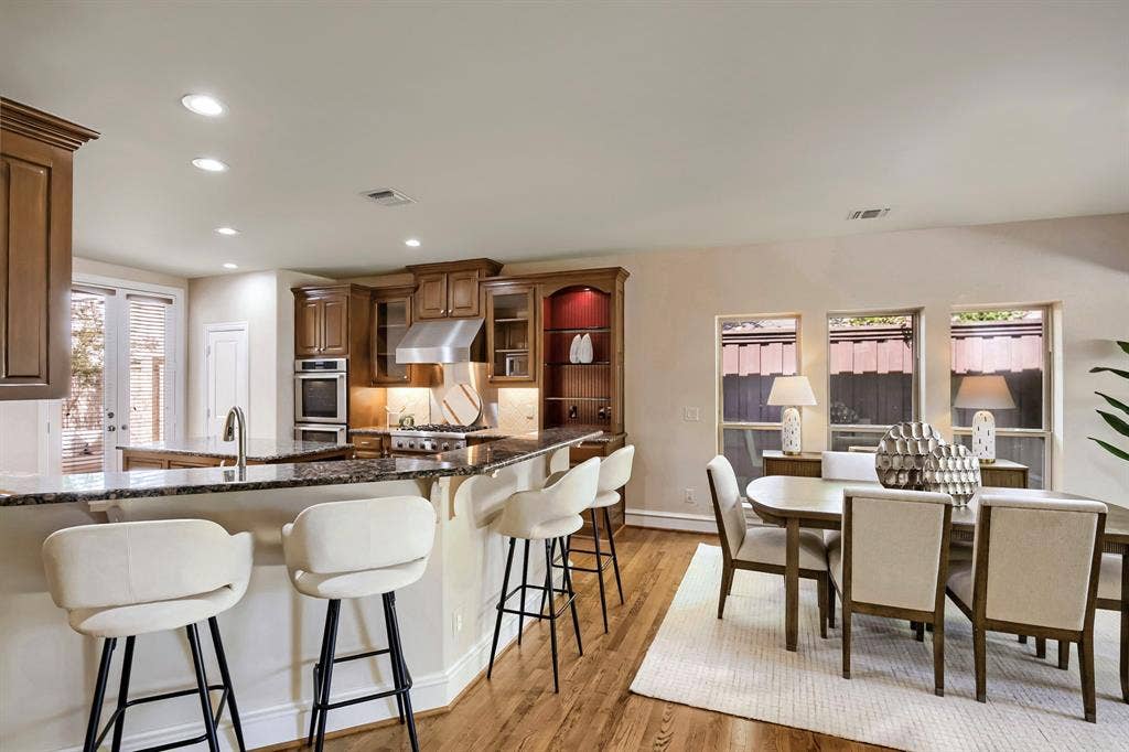 6335 Vanderbilt Avenue, Dallas, TX 75214 Kitchen has spacious bar and opens to large dining area.