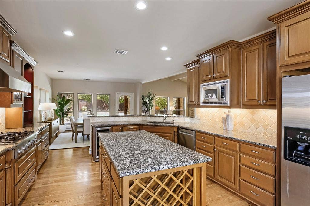 6335 Vanderbilt Avenue, Dallas, TX 75214 Granite counters and center island with wine rack and wine fridge.