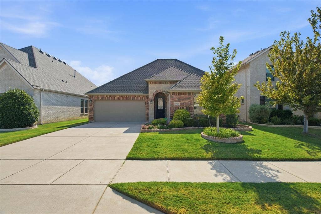 Brick and stone exterior with an attached garage