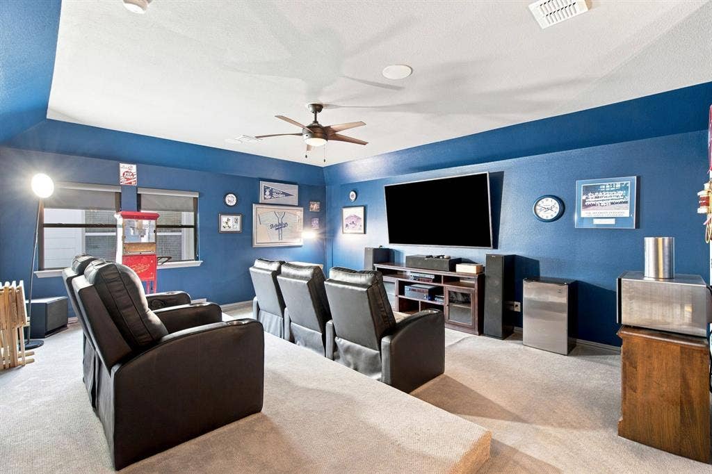 Fabulous 2nd story Media, Game room or Flex Space with ceiling fan, carpet and two windows.