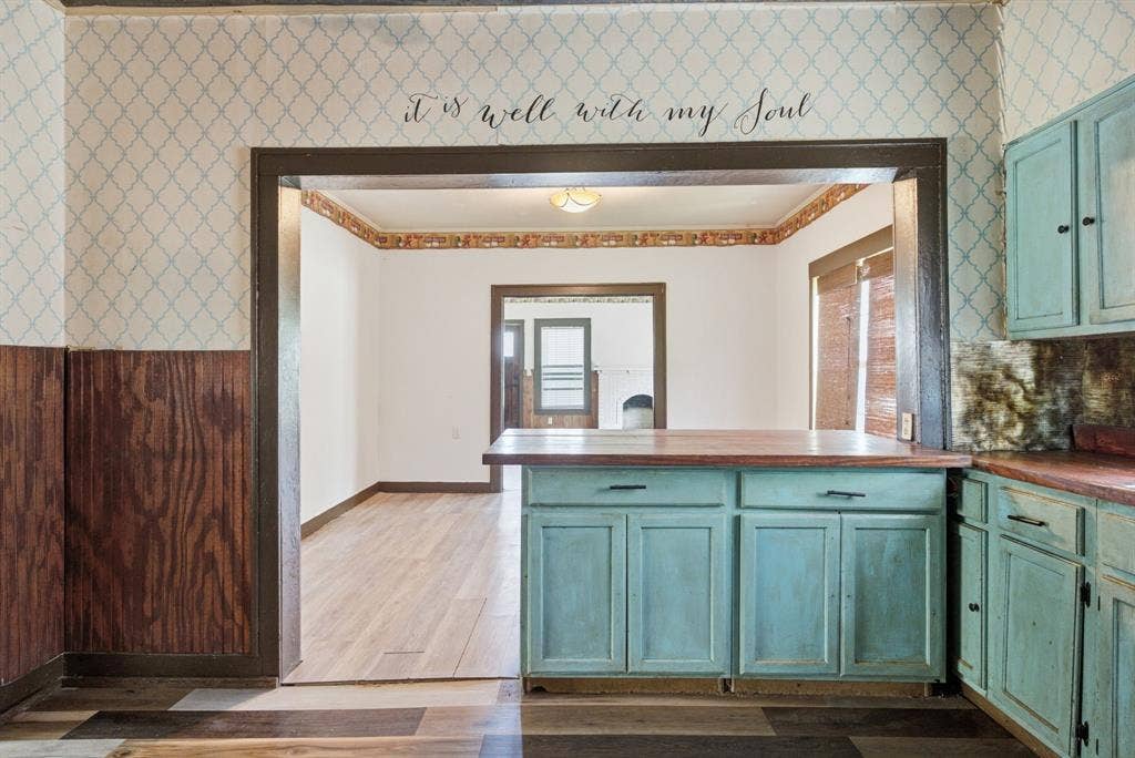506 E Longview Street, Arp, TX 75750 Wood-finish flooring throughout, complemented by a distressed wood-look island with a wood countertop