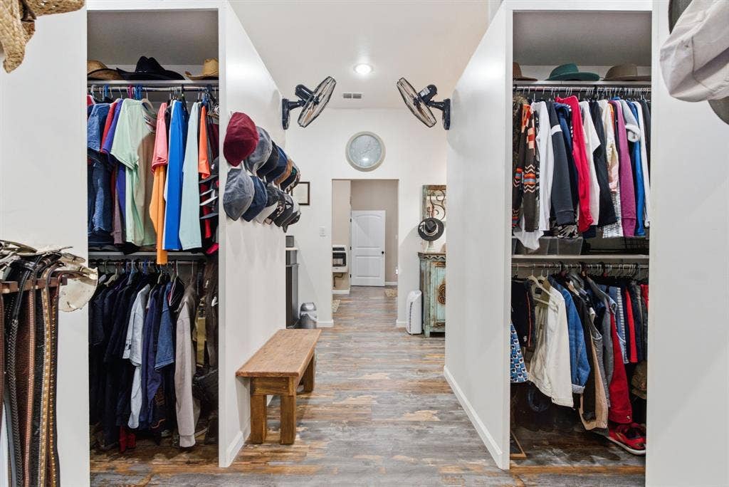 12842 Farm to Market 838, Overton, TX 75684 Hallway featuring wood-finish flooring, recessed lighting, and dual built-in closet spaces with shelving and hanging rods