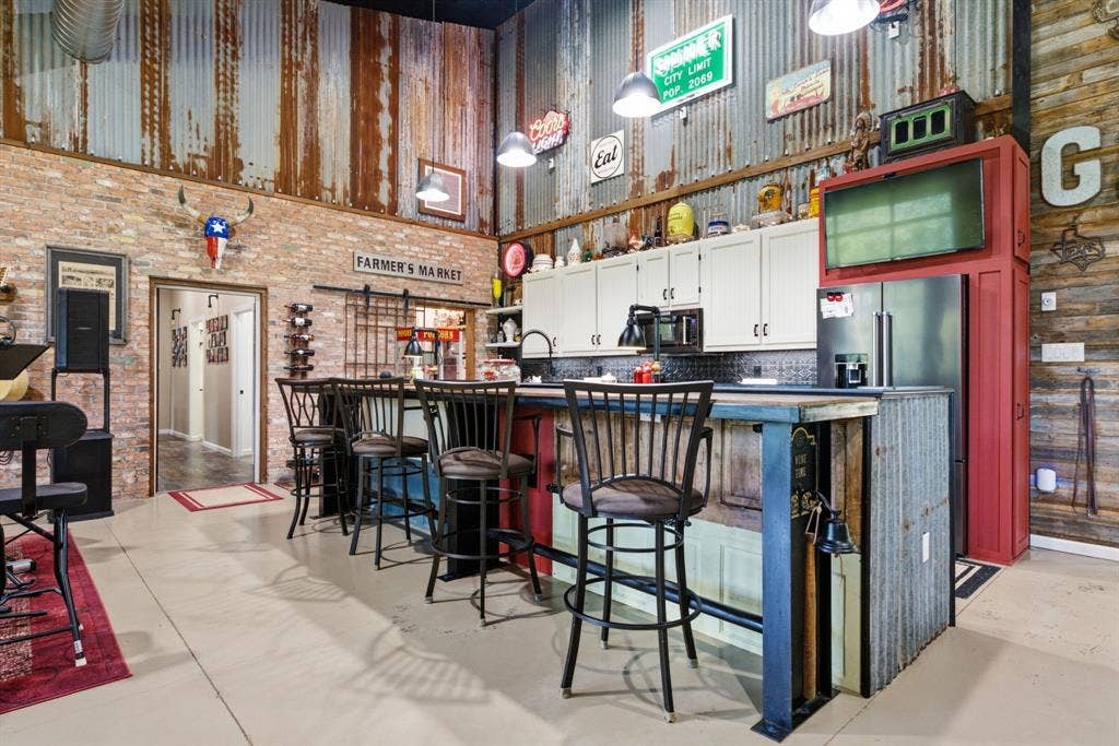 12842 Farm to Market 838, Overton, TX 75684 Exposed brick walls, corrugated metal wall accents, and an open-concept kitchen with white cabinetry