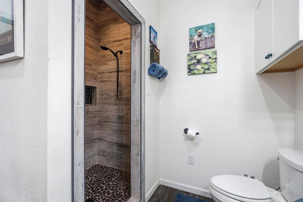 12842 Farm to Market 838, Overton, TX 75684 Walk-in shower with wood-look tile surround and a pebble tile floor