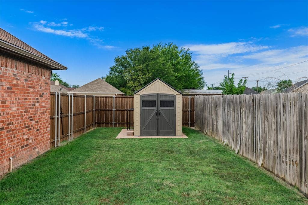 1308 Madeline Street, Commerce, TX 75428 Storage Shed in one of the yards