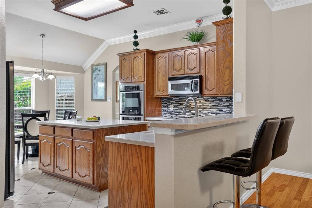3002 Silver Springs Way, Rowlett, TX 75089 Breakfast Bar, Corian Counter Top.