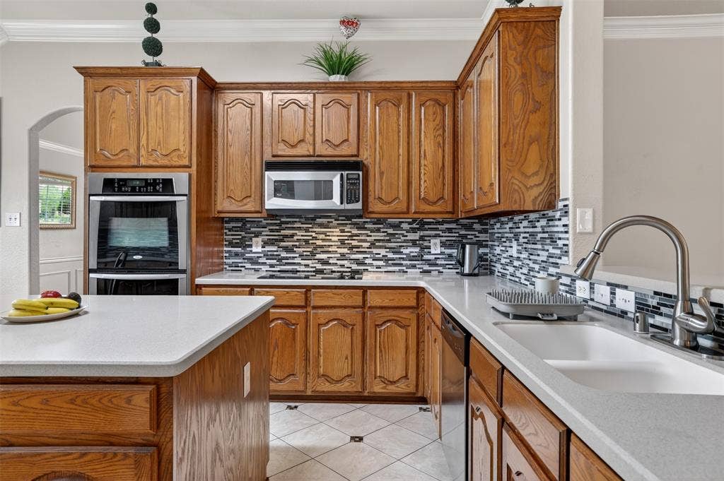 3002 Silver Springs Way, Rowlett, TX 75089 Double Oven, Built-In Microwave, Designed Backsplash, High-End Faucet, Corian Counter Top.
