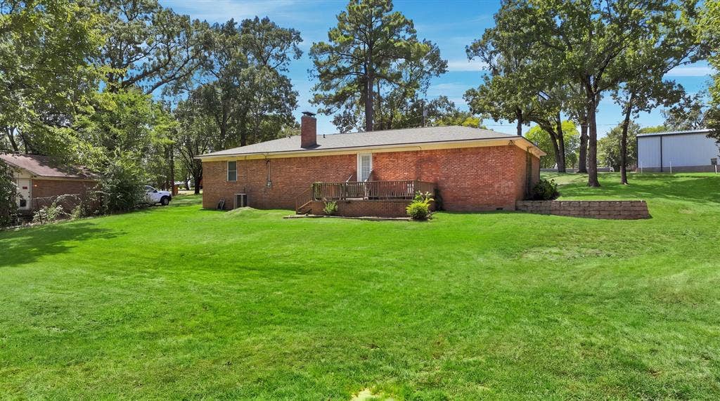 21121 County Road 1291, Flint, TX 75762 Expansive green lawn with mature trees and a brick-sided residence