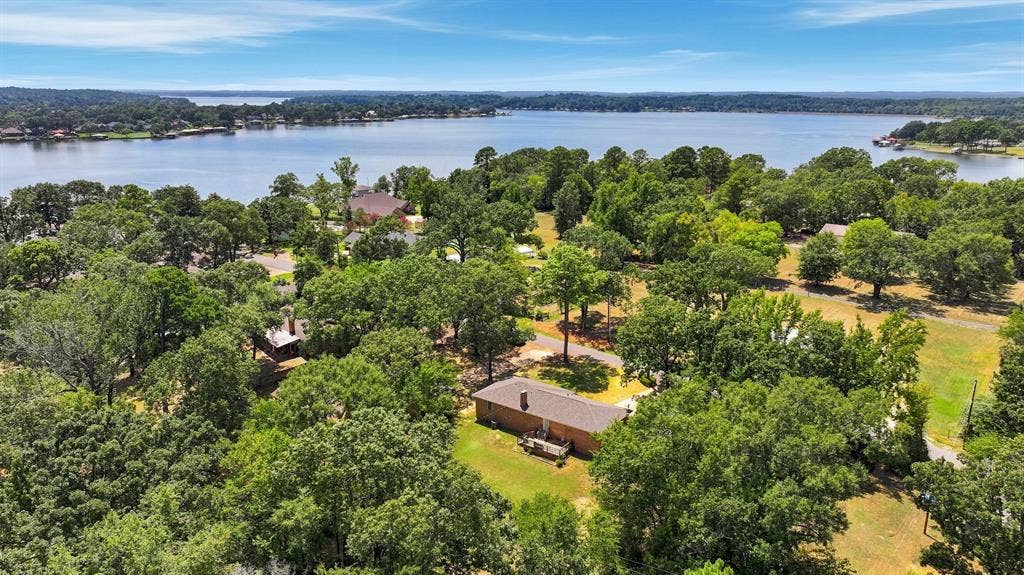 21121 County Road 1291, Flint, TX 75762 Expansive lakefront property featuring a brick exterior, mature trees, and a spacious lot with water frontage