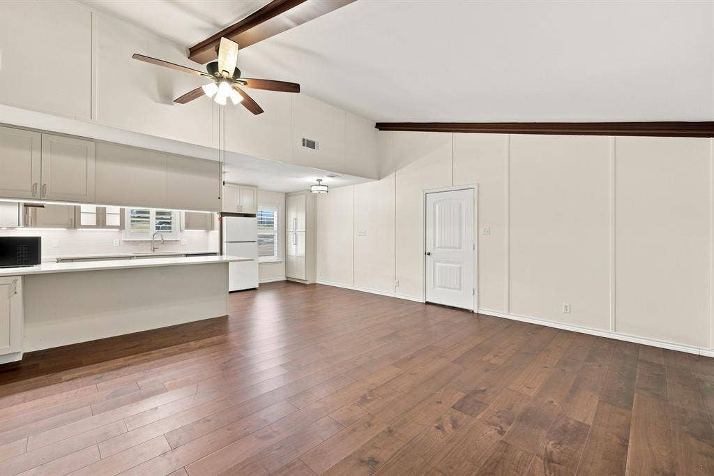 21121 County Road 1291, Flint, TX 75762 Vaulted ceiling with exposed wood beams and a ceiling fan
