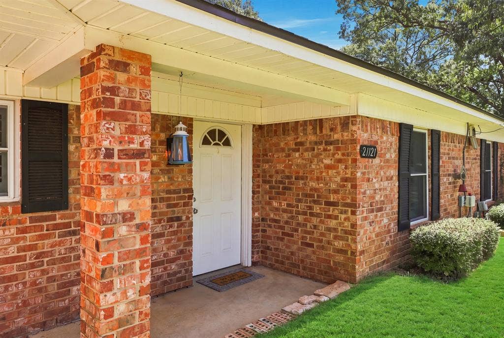 21121 County Road 1291, Flint, TX 75762 Brick exterior with white trim, covered front entry, and multiple windows with dark shutters