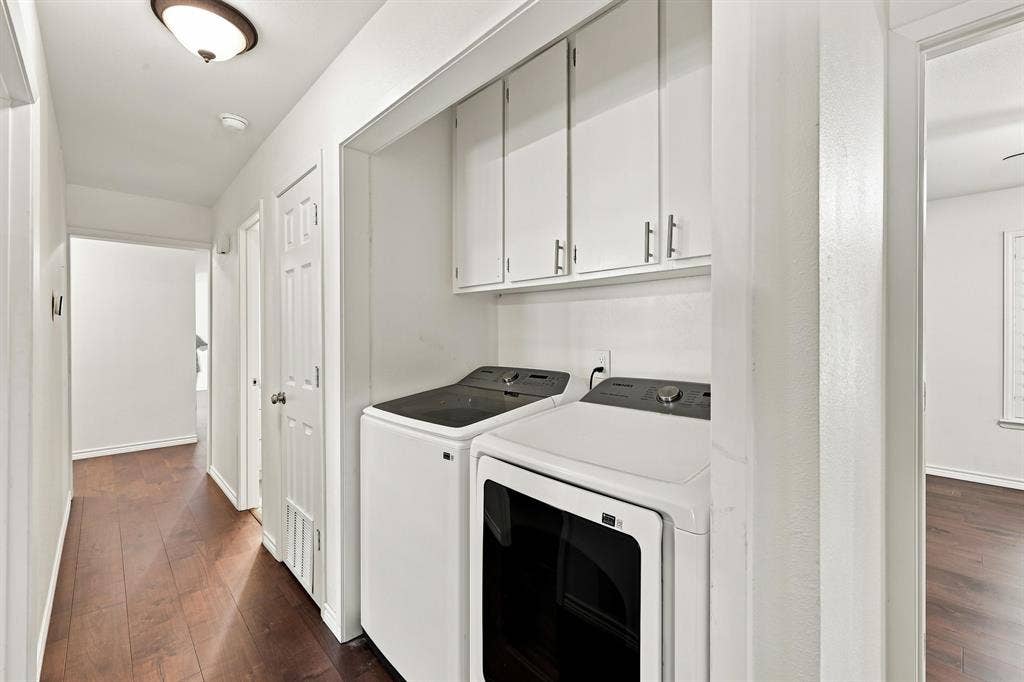 21121 County Road 1291, Flint, TX 75762 Laundry area with overhead white cabinetry, wood-finish flooring, and white walls