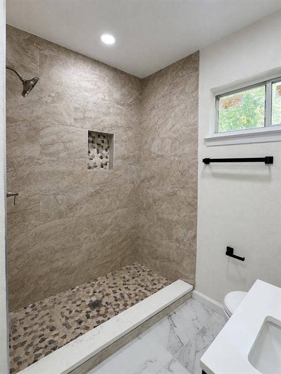 1842 Delmar Drive, Garland, TX 75040 Walk-in shower with natural stone-look wall tile and a pebble floor
