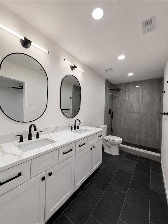 1842 Delmar Drive, Garland, TX 75040 Dual vanity with white shaker-style cabinetry, white countertops, and matte black hardware