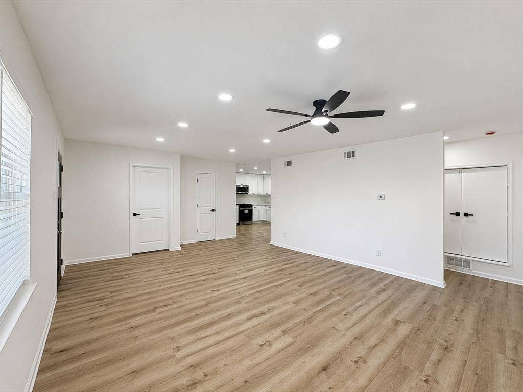 1842 Delmar Drive, Garland, TX 75040 Spacious room with wood-finish flooring, recessed lighting, and a ceiling fan
