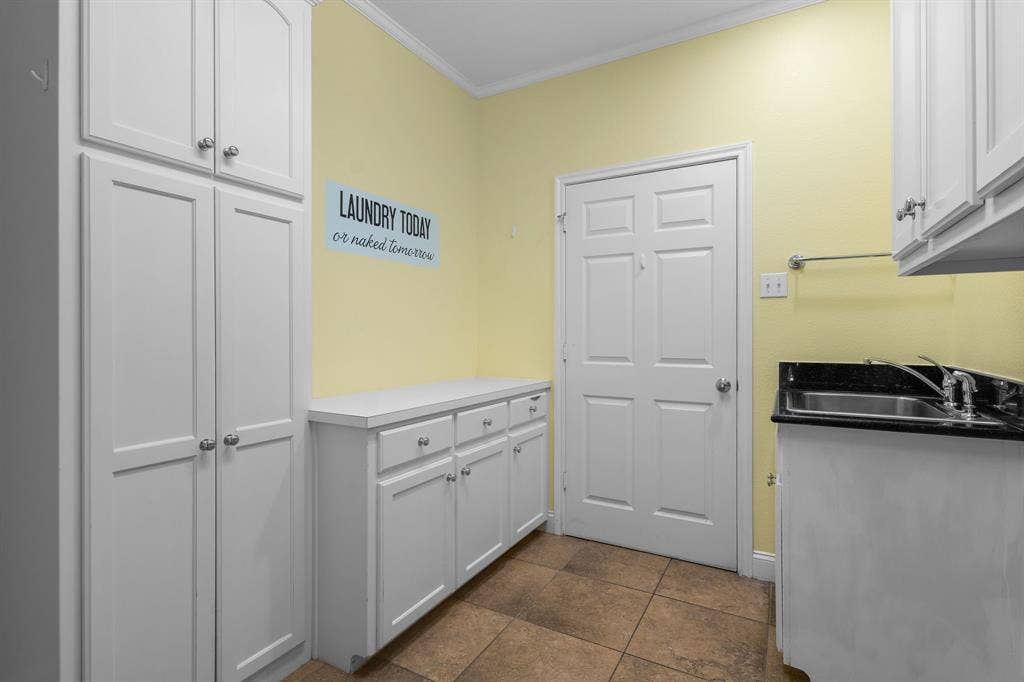 367 Elm Grove Circle, Waco, TX 76657 Built-in cabinetry with ample storage, integrated sink, stone countertop, tiled flooring, and a solid panel door