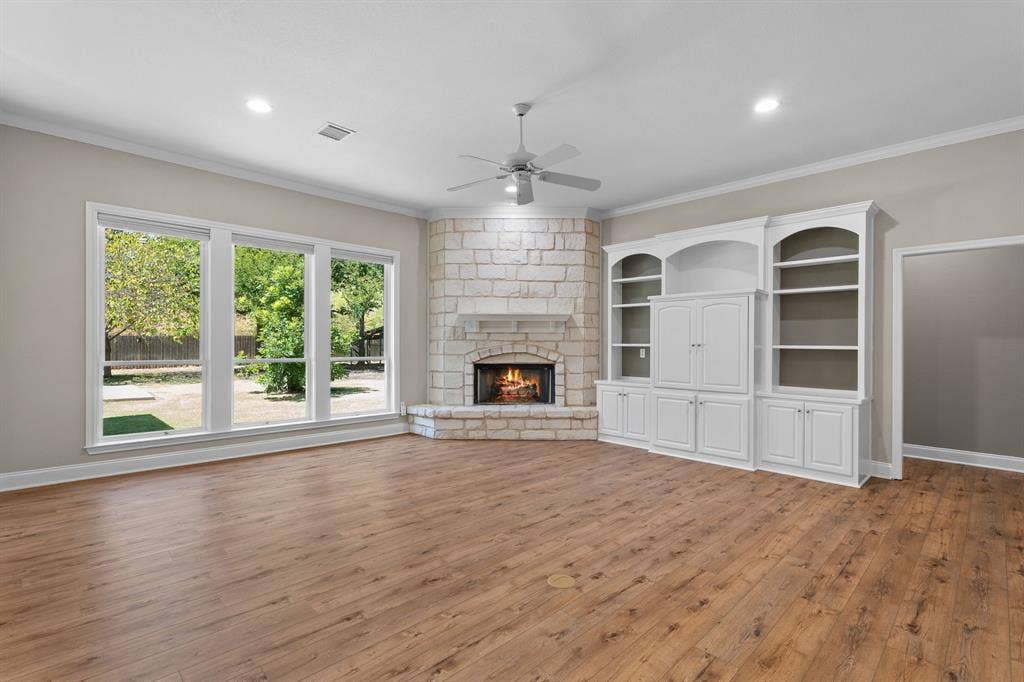 367 Elm Grove Circle, Waco, TX 76657 Wood-finish flooring, stone-clad corner fireplace, built-in cabinetry with shelving, recessed lighting, and a ceiling fan
